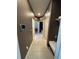 Long hallway with multiple doors leading to bedrooms and bathroom at 11854 Thicket Wood Dr, Riverview, FL 33579