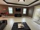 Bright living room with fireplace and large TV at 11854 Thicket Wood Dr, Riverview, FL 33579