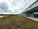 Backyard view of a house showing a covered patio and water view at 13719 Emerald Fields Dr, Hudson, FL 34667