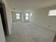 Spacious bedroom with large windows and wood-look flooring at 13719 Emerald Fields Dr, Hudson, FL 34667