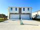 Two-story house with a two-car garage and stone accents at 13719 Emerald Fields Dr, Hudson, FL 34667