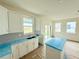 Modern kitchen with white cabinets and gray herringbone backsplash at 13992 Emerald Fields Dr, Hudson, FL 34667