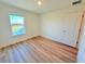 Bright bedroom with wood-look floors and water views at 13998 Emerald Fields Dr, Hudson, FL 34667