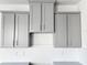 Gray kitchen cabinets with brushed nickel hardware at 13998 Emerald Fields Dr, Hudson, FL 34667