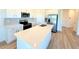 Modern kitchen island with white cabinets and quartz countertops at 13998 Emerald Fields Dr, Hudson, FL 34667