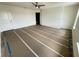 Spacious bedroom with wood-look flooring and a walk-in closet at 14016 Emerald Fields Dr, Hudson, FL 34667