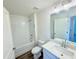 Clean bathroom with white subway tiles, quartz vanity, and a tub at 14024 Emerald Fields Dr, Hudson, FL 34667