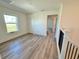 Spacious loft bedroom with large window, and light wood flooring at 14024 Emerald Fields Dr, Hudson, FL 34667