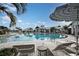 Community pool with lounge chairs and umbrellas at 17130 Savory Mist Cir, Lakewood Ranch, FL 34211