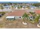 Aerial view showcasing a single-story home with a tile roof and a screened lanai at 1718 S Pebble Beach Blvd, Sun City Center, FL 33573