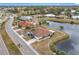 Aerial view of the community, showcasing a lake and villas at 1718 S Pebble Beach Blvd, Sun City Center, FL 33573