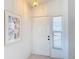 Bright entryway with white door and floral artwork at 1718 S Pebble Beach Blvd, Sun City Center, FL 33573