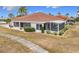 Single story home exterior with tile roof and screened lanai at 1718 S Pebble Beach Blvd, Sun City Center, FL 33573