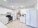 Kitchen with stainless steel appliances and white cabinetry at 1718 S Pebble Beach Blvd, Sun City Center, FL 33573