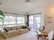 Spacious living room featuring a large window overlooking the lake at 1718 S Pebble Beach Blvd, Sun City Center, FL 33573