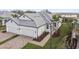 Two-car garage home with gray tile roof and lush landscaping at 18040 Cherished Loop, Bradenton, FL 34211