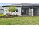 Screened patio with landscaping, and a grassy backyard at 18040 Cherished Loop, Bradenton, FL 34211