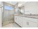 Spa-like bathroom with a large shower, double vanity, and granite countertops at 18040 Cherished Loop, Bradenton, FL 34211