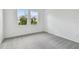 Well-lit bedroom featuring grey carpet and large windows at 18040 Cherished Loop, Bradenton, FL 34211