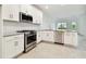 Modern kitchen with stainless steel appliances and granite countertops at 18040 Cherished Loop, Bradenton, FL 34211