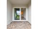 Sliding glass doors leading to a covered patio with brick pavers at 18040 Cherished Loop, Bradenton, FL 34211