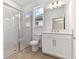 Modern bathroom with white cabinets, marble shower, and double vanity at 18178 Cherished Loop, Bradenton, FL 34211