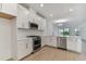 Modern kitchen with white cabinets, stainless steel appliances, and quartz countertops at 18178 Cherished Loop, Bradenton, FL 34211