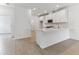 Modern kitchen with white cabinets, quartz countertops, and stainless steel appliances at 18178 Cherished Loop, Bradenton, FL 34211