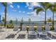 Relaxing poolside loungers overlooking a scenic waterfront view at 1885 Bilge Ln, Sarasota, FL 34240