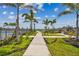 Walkway leading to the lake with palm trees and playground views at 1885 Bilge Ln, Sarasota, FL 34240