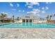 Community pool with adjacent clubhouse and lounge chairs at 1905 Swivel Ln, Sarasota, FL 34240