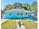 Charming light blue house with landscaped lawn and walkway at 2217 Thrace St, Tampa, FL 33605