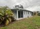 Backyard view with screened patio and landscaping at 2275 Pine View Cir, Sarasota, FL 34231