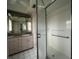 Bathroom with double sinks, shower, and grab bars at 2275 Pine View Cir, Sarasota, FL 34231