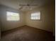 Bright bedroom with two windows and ceiling fan at 2275 Pine View Cir, Sarasota, FL 34231