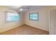 Bright bedroom featuring two windows and neutral wall colors at 2275 Pine View Cir, Sarasota, FL 34231