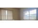 Bedroom with two windows and vertical blinds at 2275 Pine View Cir, Sarasota, FL 34231