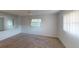 Well-lit bedroom featuring carpeted floors and large windows at 2275 Pine View Cir, Sarasota, FL 34231