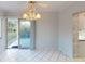 Dining room with tile floors, sliding glass doors and chandelier at 2275 Pine View Cir, Sarasota, FL 34231