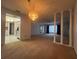 Bright dining room with chandelier and view of kitchen at 2275 Pine View Cir, Sarasota, FL 34231