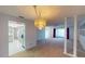 Dining room with chandelier and view into the kitchen and living room at 2275 Pine View Cir, Sarasota, FL 34231