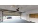 Attached garage with open door and storage shelving at 2275 Pine View Cir, Sarasota, FL 34231