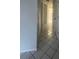 Clean hallway with tile flooring and built-in closet at 2275 Pine View Cir, Sarasota, FL 34231