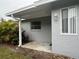 Gray house exterior with patio and landscaping at 2275 Pine View Cir, Sarasota, FL 34231