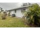 Gray house exterior with AC unit and landscaping at 2275 Pine View Cir, Sarasota, FL 34231