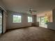 Bright living room with carpet, sliding glass doors, and ceiling fan at 2275 Pine View Cir, Sarasota, FL 34231