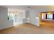 Living room with view into dining area and kitchen, featuring light walls and carpeting at 2275 Pine View Cir, Sarasota, FL 34231