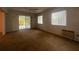 Living room with carpet, sliding glass doors, and ceiling fan at 2275 Pine View Cir, Sarasota, FL 34231