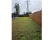 Large backyard with grassy area and wooden fence at 2529 Ednor St, Port Charlotte, FL 33952