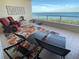 Relaxing balcony with lounge chairs and stunning water views at 3060 Grand Bay Blvd # 174, Longboat Key, FL 34228